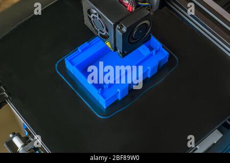 The 3D printer prints blue plastic model. modern technology. top view Stock Photo