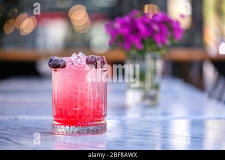 Red and Pink Fresh Colorful Exotic Alcoholic Cocktail with Blackberry on the Wooden Table. Red and Pink Mojito Stock Photo