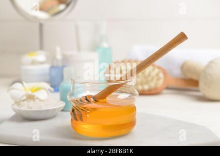 Jar with honey and spa items on table Stock Photo