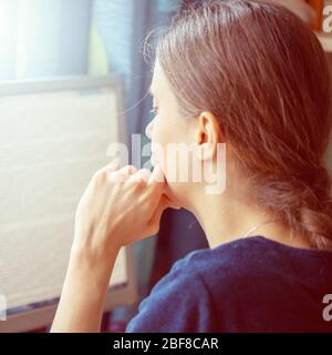 Girl student is studying online. Young girl is reading lecture at home computer monitor. Distance E education during quarantine. Coronavirus pandemic. Stock Photo