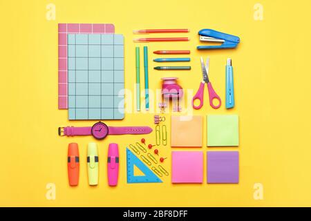 Set of school supplies with clock on color background Stock Photo