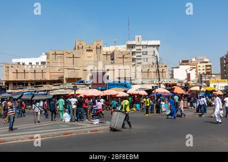 DAKAR, SENEGAL - NOVEMBER 11, 2019: People working and traffic at Senegal capital Dakar, West Africa. Stock Photo