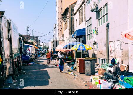 DAKAR, SENEGAL - NOVEMBER 11, 2019: People working and traffic at Senegal capital Dakar, West Africa. Stock Photo