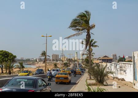 DAKAR, SENEGAL - NOVEMBER 11, 2019: People working and traffic at Senegal capital Dakar, West Africa. Stock Photo