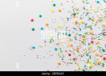 Cake topping sprinkles isolated on white background - spray of sweet star, ball, and oblong shapes with space for text Stock Photo