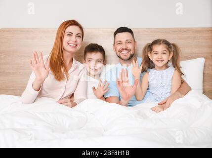 Family using video chat in bedroom Stock Photo