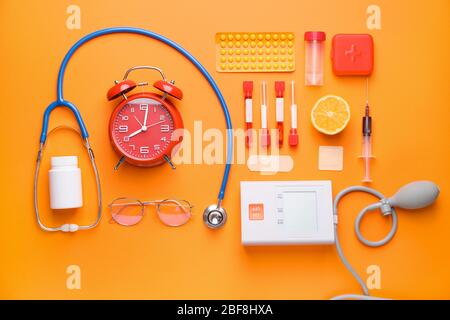Set of medical supplies with alarm clock on color background Stock Photo