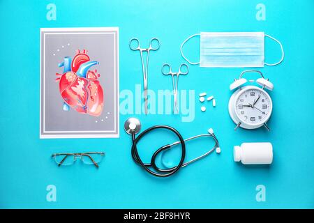 Set of medical supplies with alarm clock on color background Stock Photo