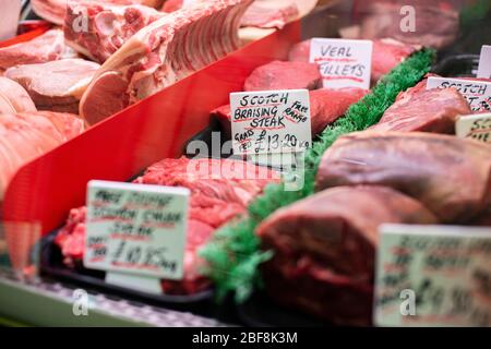 A range of qualityhigh-welfare meat on display in a butcher shop Stock Photo