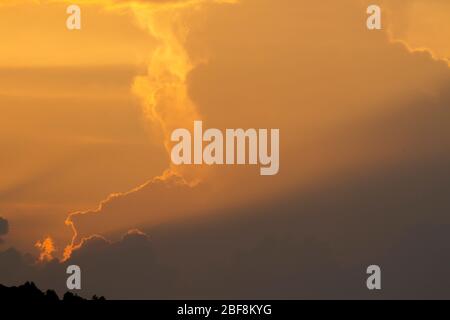 sunset orange and yellow cumulus clouds in a summer day Stock Photo
