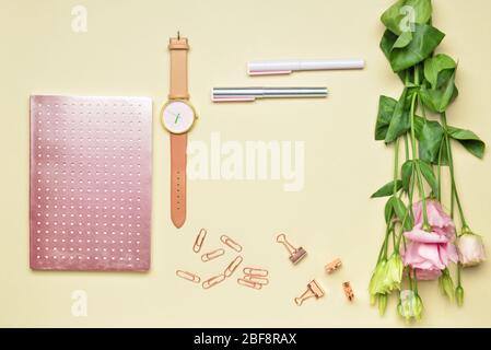 Frame made of school supplies with clock and flowers on color background Stock Photo