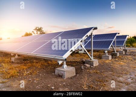 Solar panel on sky sunset background in the desert. Ecological power generator. Alternative energy source. Stock Photo