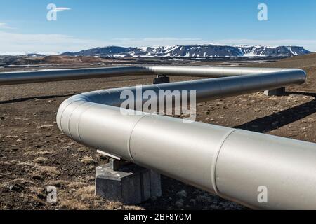 Near Myvatn, north-east Iceland. Insulated pipes carry high pressure steam from volcanic boreholes to the Krafla geothermal power plant Stock Photo