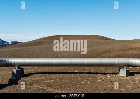 Near Myvatn, north-east Iceland. Insulated pipes carry high pressure steam from volcanic boreholes to the Krafla geothermal power plant Stock Photo