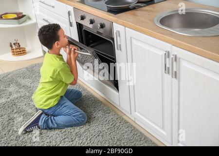 Careless child at hot stove kid touching oven Vector Image