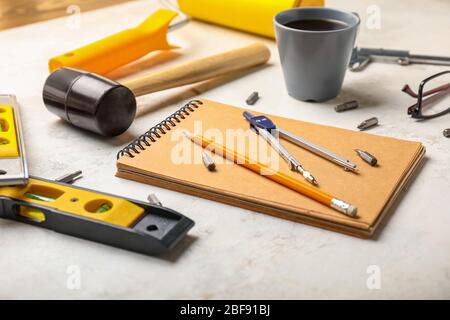 Builder's tools with notebook on white background Stock Photo