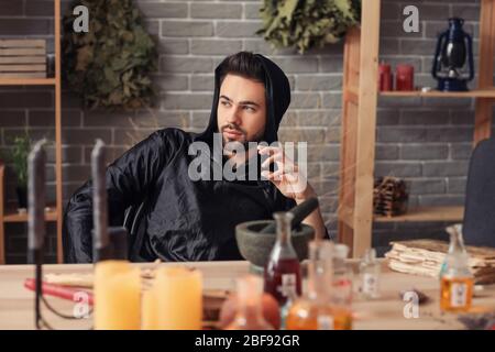 Male alchemist making elixir in laboratory Stock Photo