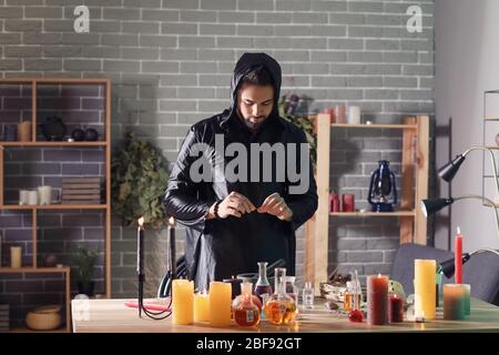 Male alchemist making elixir in laboratory Stock Photo