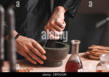 Male alchemist making elixir in laboratory, closeup Stock Photo