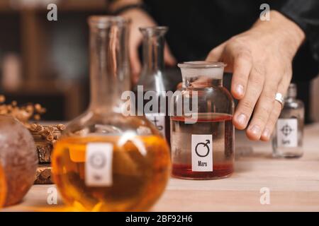Male alchemist making elixir in laboratory, closeup Stock Photo