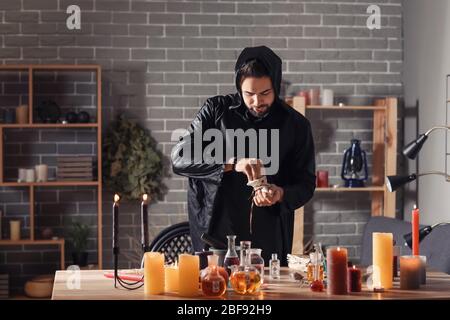 Male alchemist making elixir in laboratory Stock Photo