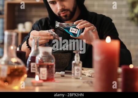 Male alchemist making elixir in laboratory Stock Photo