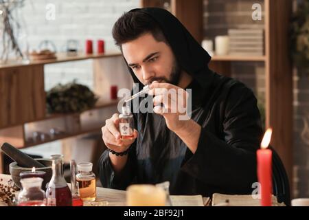 Male alchemist making elixir in laboratory Stock Photo