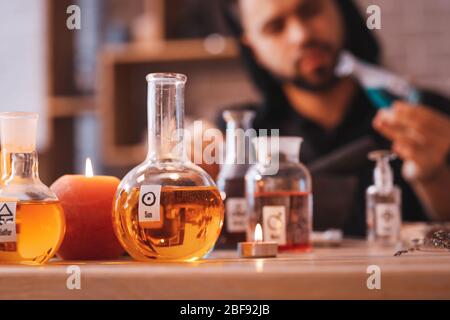 Flasks with potion on table in alchemist's laboratory Stock Photo