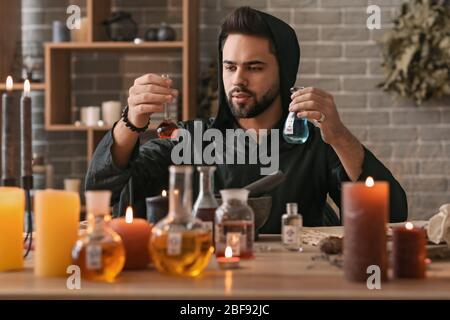 Male alchemist making elixir in laboratory Stock Photo