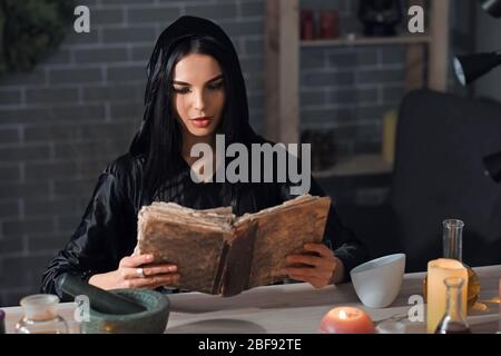 Female alchemist making elixir in laboratory Stock Photo