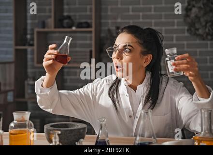 Crazy alchemist working in laboratory Stock Photo