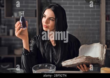 Female alchemist making elixir in laboratory Stock Photo