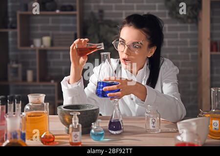 Crazy alchemist working in laboratory Stock Photo