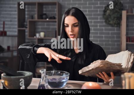 Female alchemist making elixir in laboratory Stock Photo