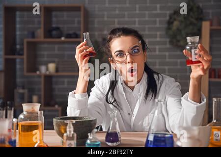 Crazy alchemist working in laboratory Stock Photo