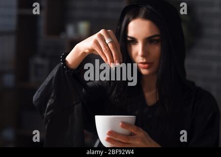 Female alchemist making elixir in laboratory Stock Photo