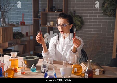 Crazy alchemist working in laboratory Stock Photo