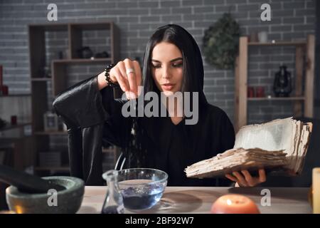 Female alchemist making elixir in laboratory Stock Photo