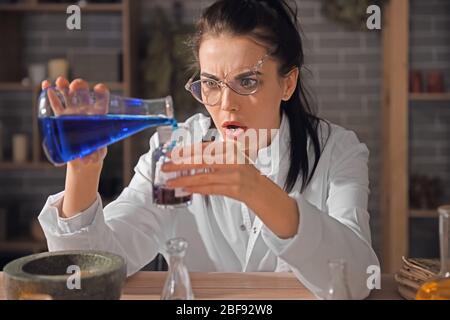 Crazy alchemist working in laboratory Stock Photo