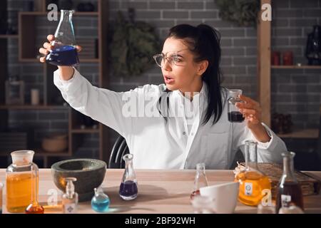 Crazy alchemist working in laboratory Stock Photo