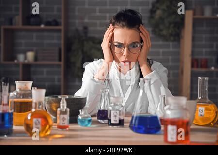Crazy alchemist working in laboratory Stock Photo