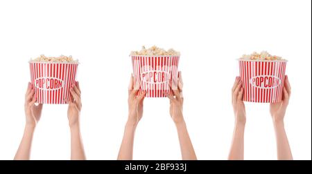 Many hands with popcorn in buckets on white background Stock Photo