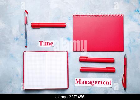 Stationery and text TIME MANAGEMENT on color background Stock Photo
