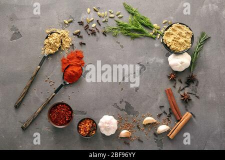 Frame made of different spices on grunge background Stock Photo