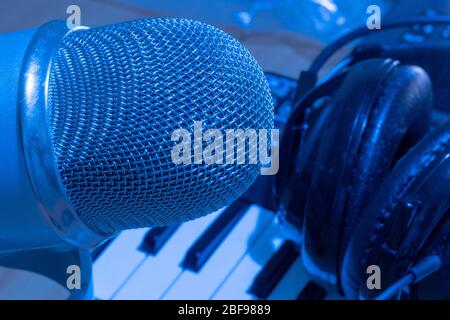 Professional music production in a sound recording studio. Headphones on musical synthesizer keyboard Stock Photo