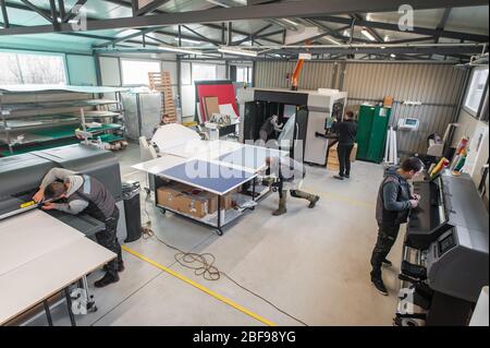 Printmaker Working Large group of worker printmaker technician operator works in digital ...