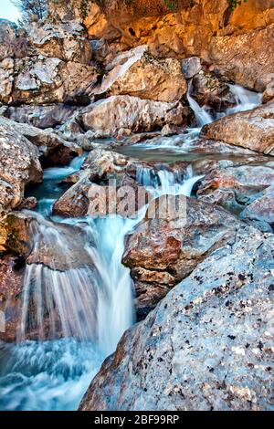 Waterfall at the 'entrance' of Havgas gorge at Katharo plateau, Agios Nikolaos municipality, Lassithi, Crete, Greece. Stock Photo