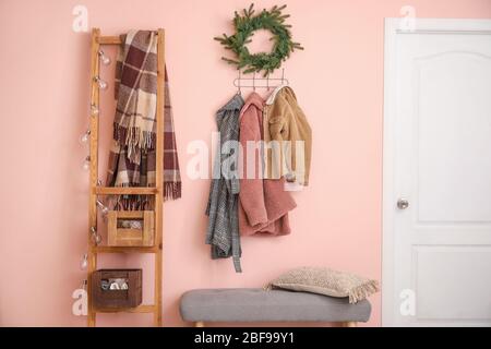 Stylish interior of modern hall with winter clothes Stock Photo