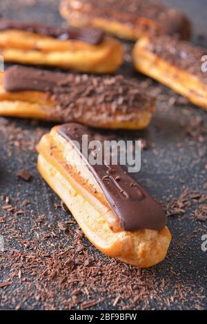 Tasty chocolate eclair on dark background Stock Photo