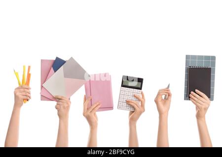 Many hands with school supplies on white background Stock Photo